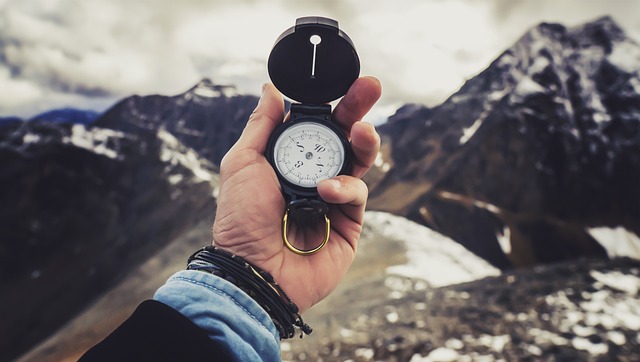 backpacking gear compass in hand